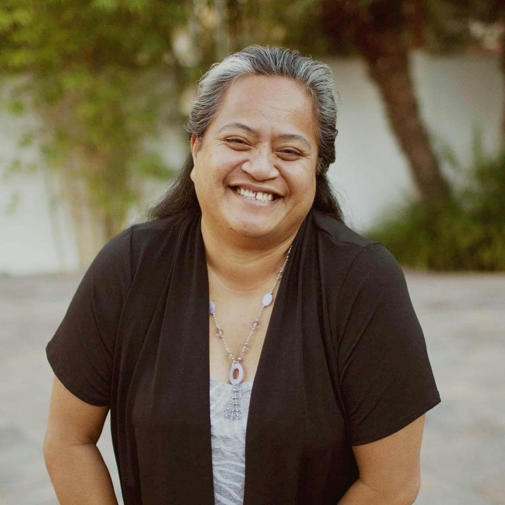 Portrait of a woman in a black blazer (team headshot).
