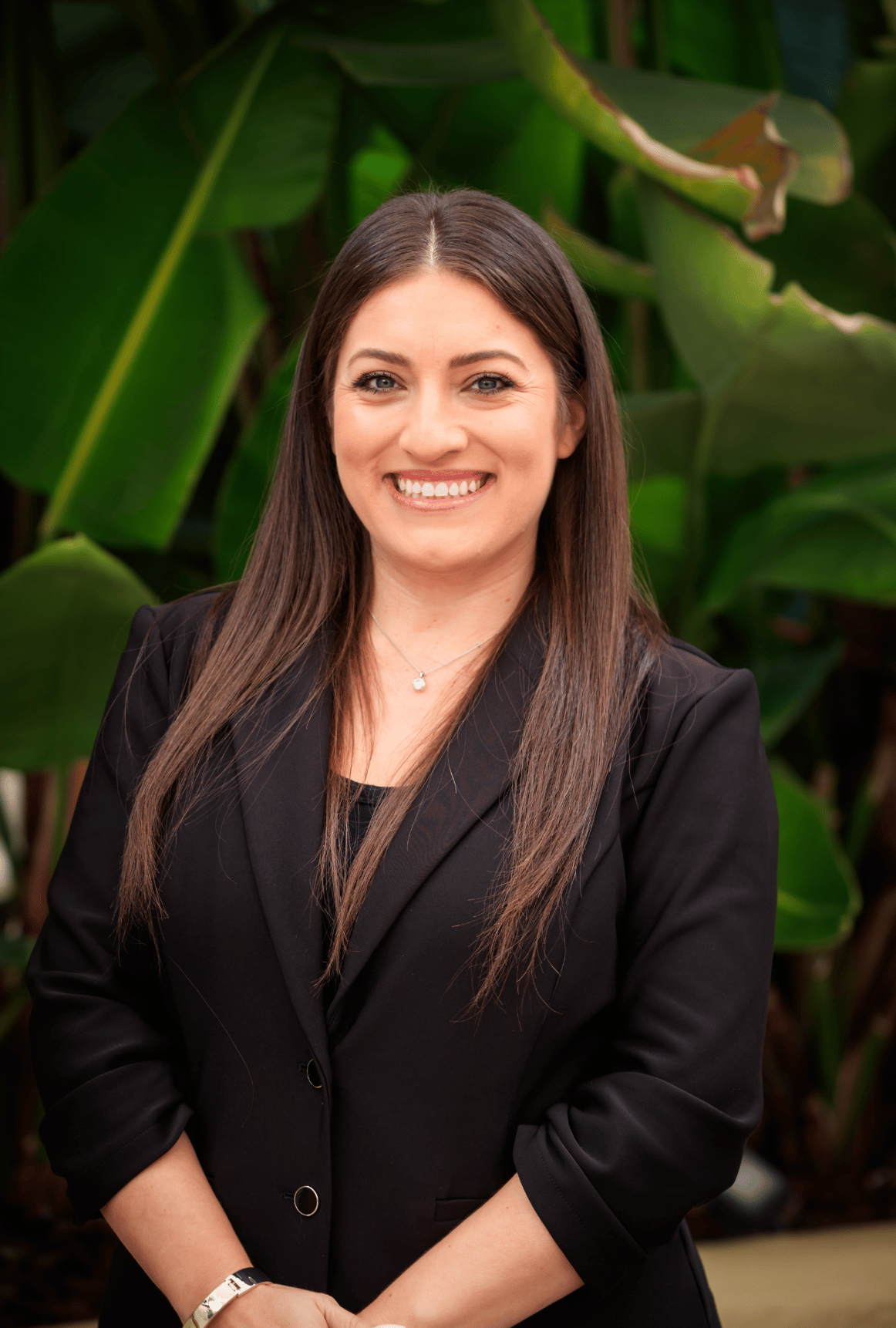 Portrait of a woman in a black blazer (team headshot).