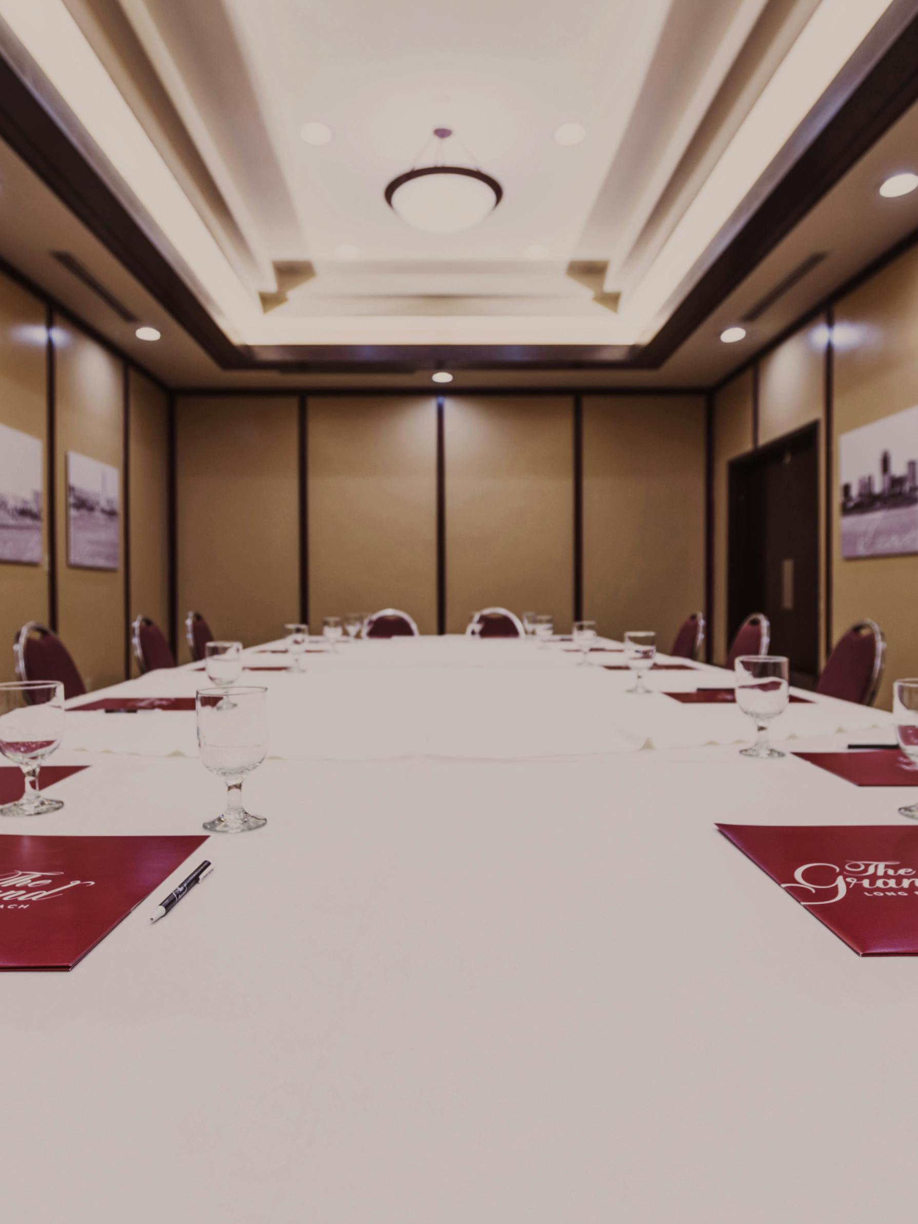 Catalina Room with rounds, stage, and warm lighting.