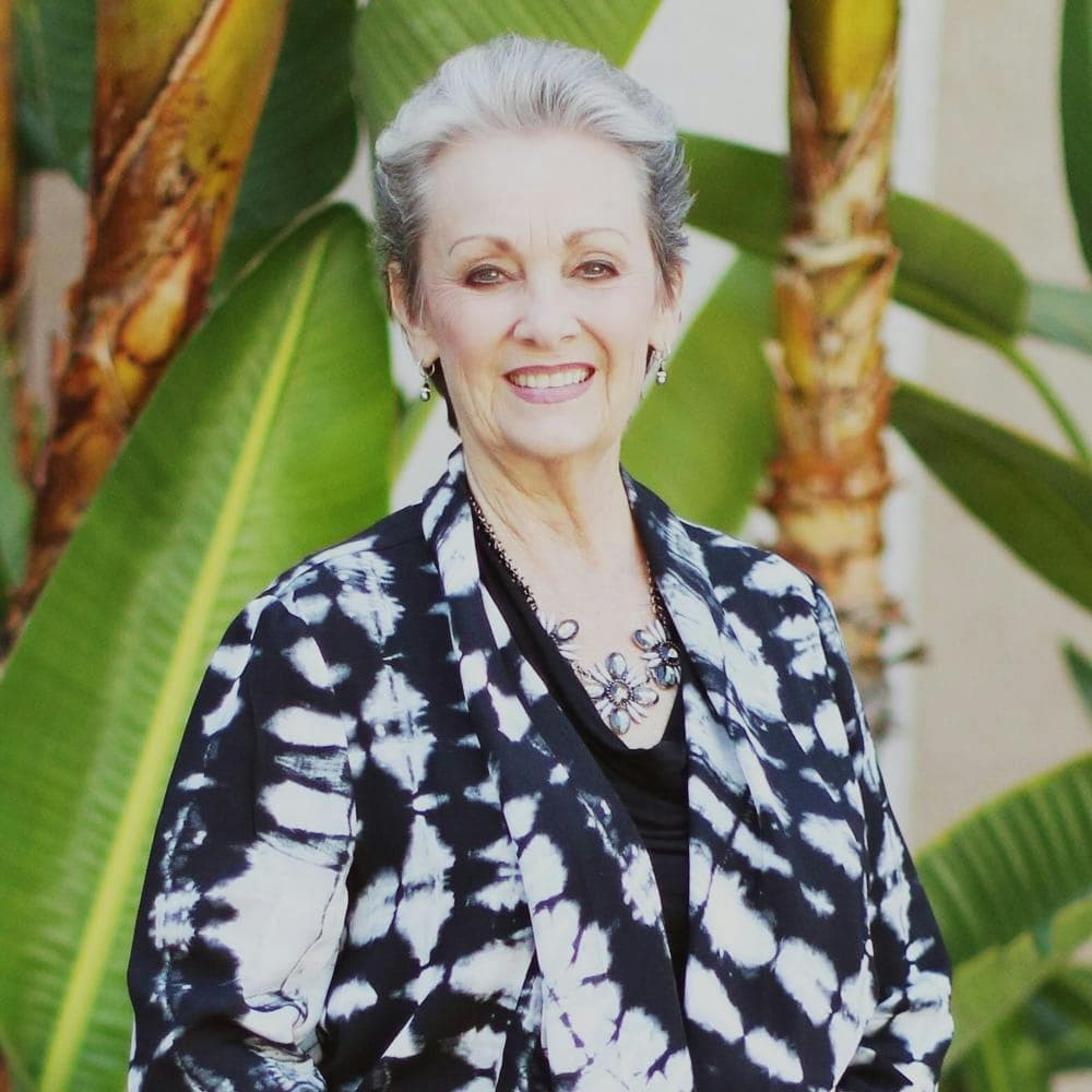 Portrait of a woman in a black blazer (team headshot).
