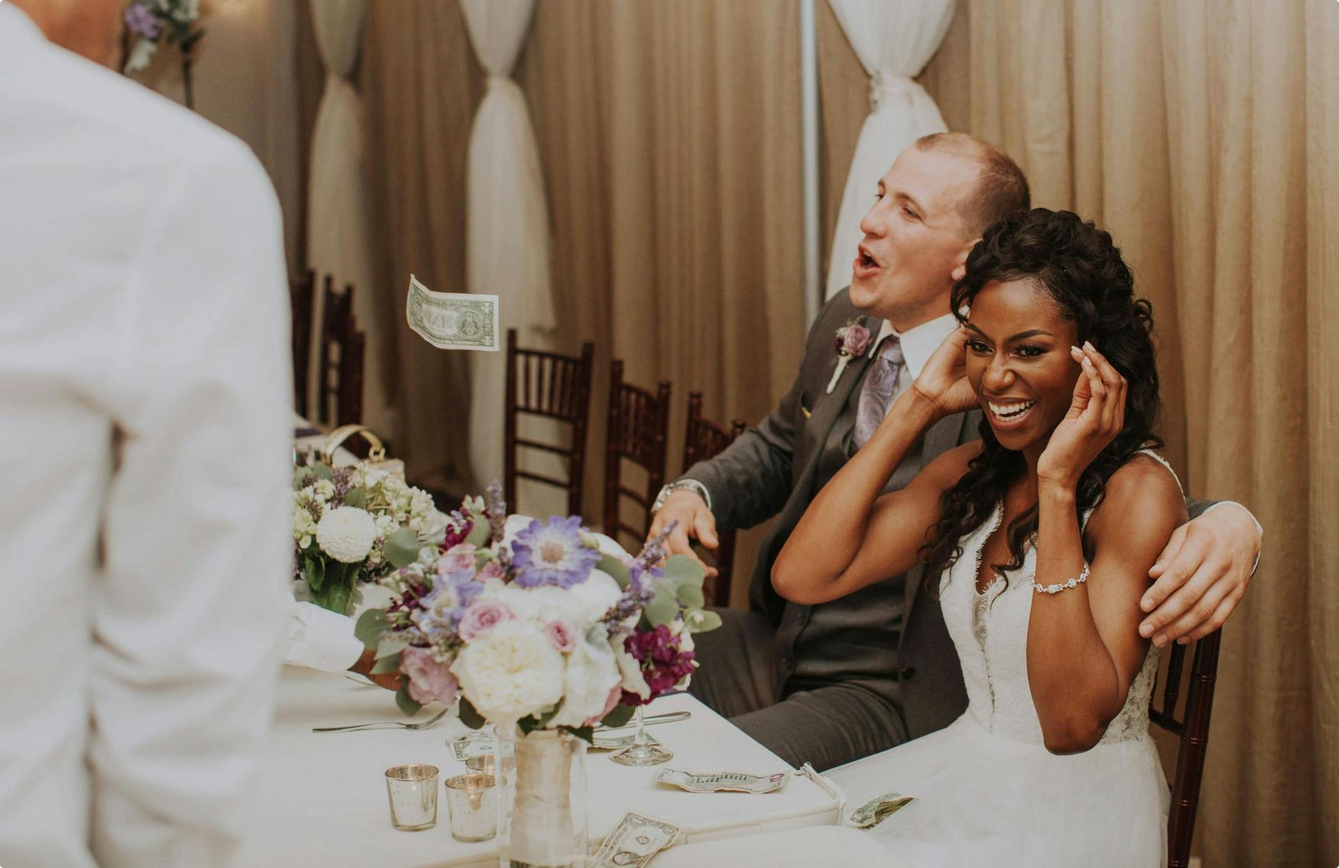 Wedding reception with dance floor, DJ, and blue lighting.