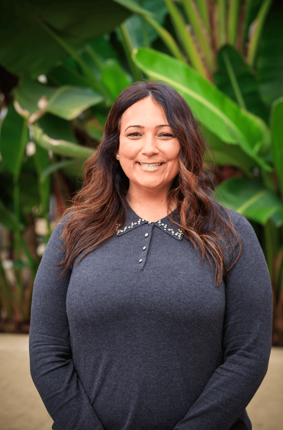 Portrait of a woman in a black blazer (team headshot).