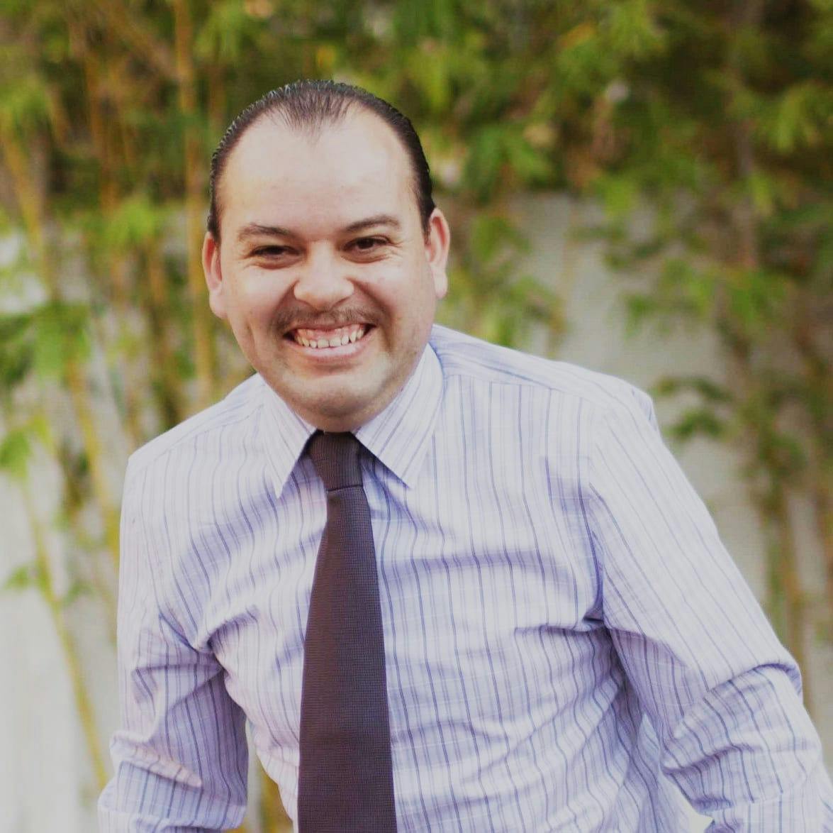 Portrait of a man in a suit jacket (team headshot).