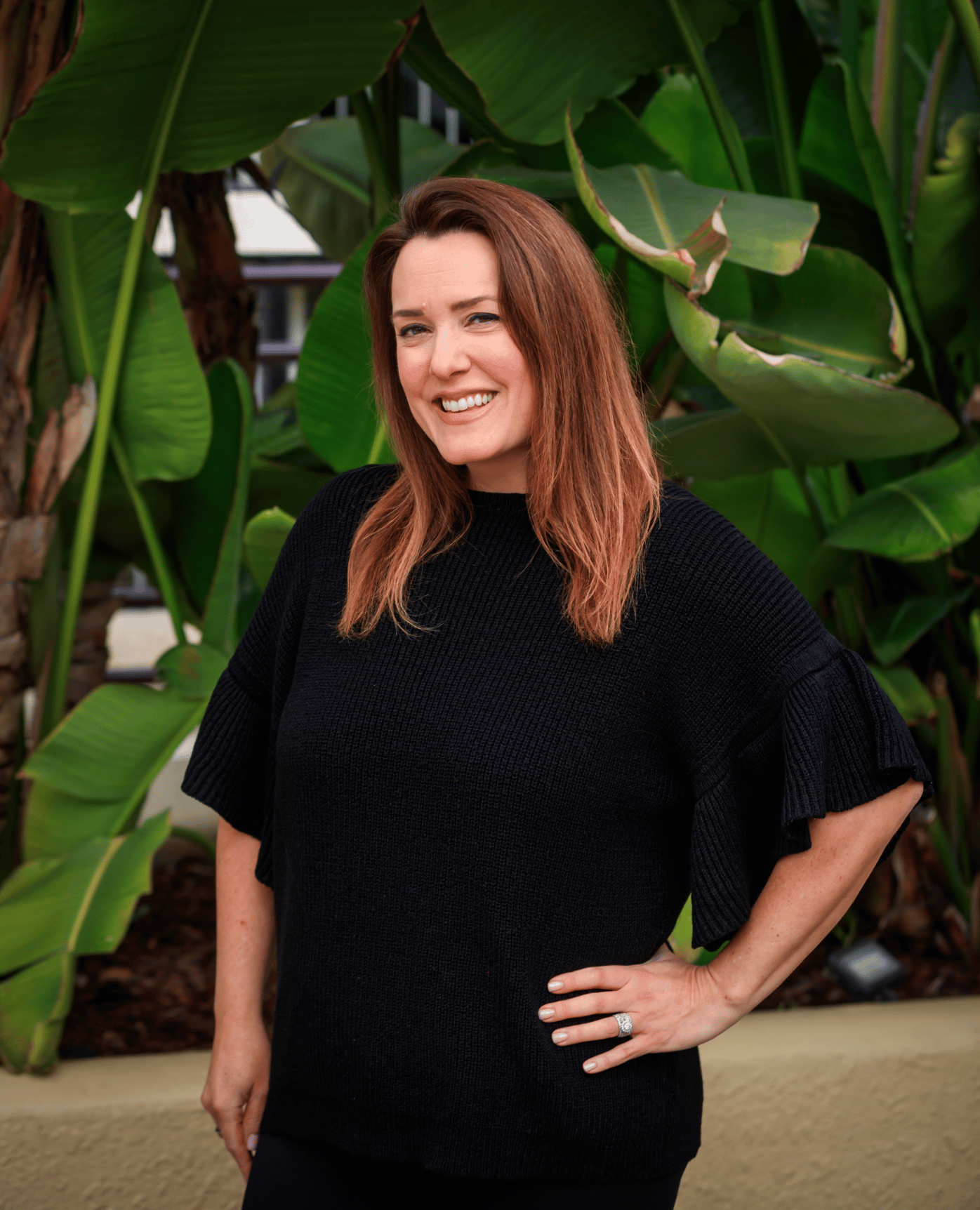 Portrait of a woman in a black blazer (team headshot).