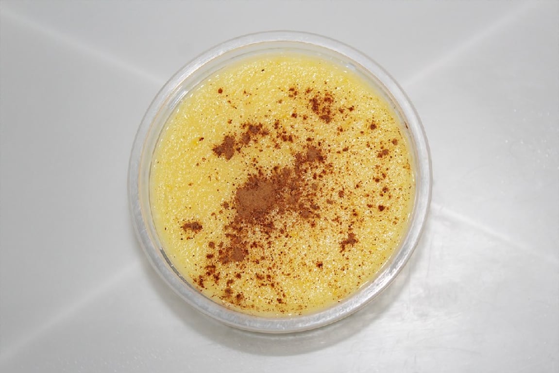 Kukuřičná kaše se skořicí ve skleněné misce na bílém ubrusu