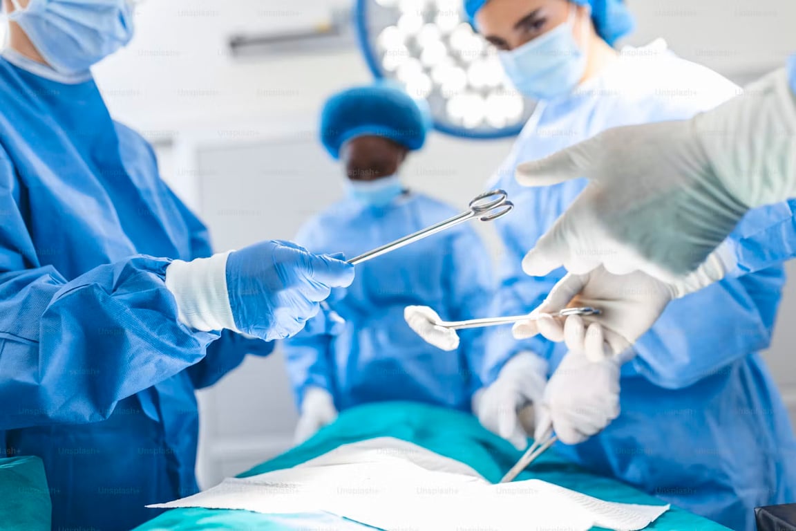 Surgical instruments being handed to a surgeon in an operating room