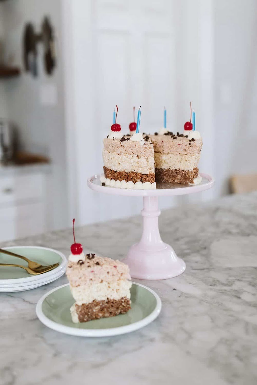 A Neapolitan Rice Krispie Treat Cake with chocolate, vanilla, and strawberry layers.