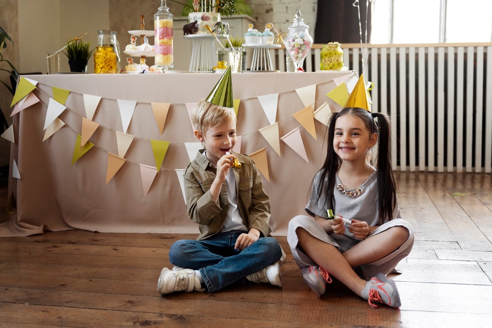 Indoor winter birthday party with fairy lights and cosy decorations.
