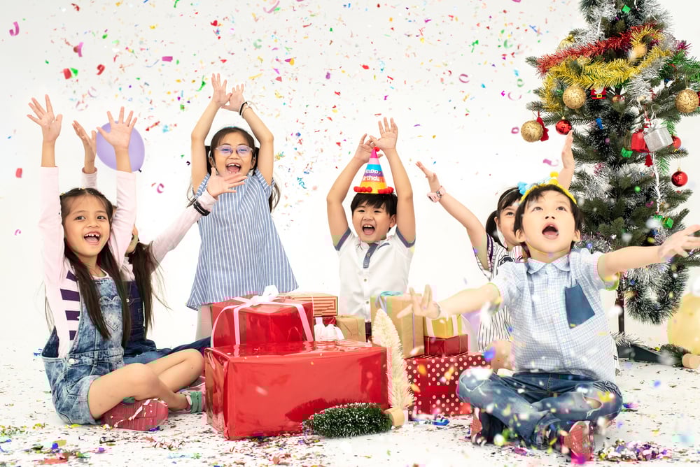 Kids sledding and skating at an outdoor winter birthday party.
