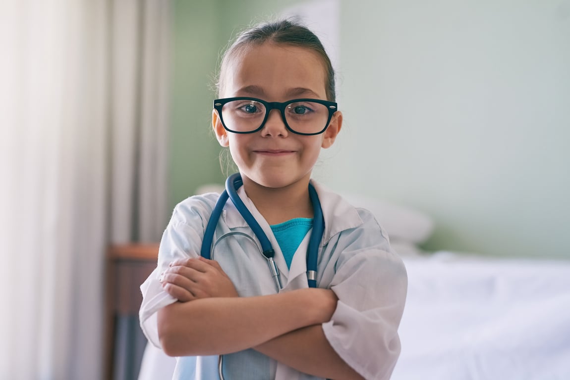 Child dressed as a doctor smiling
