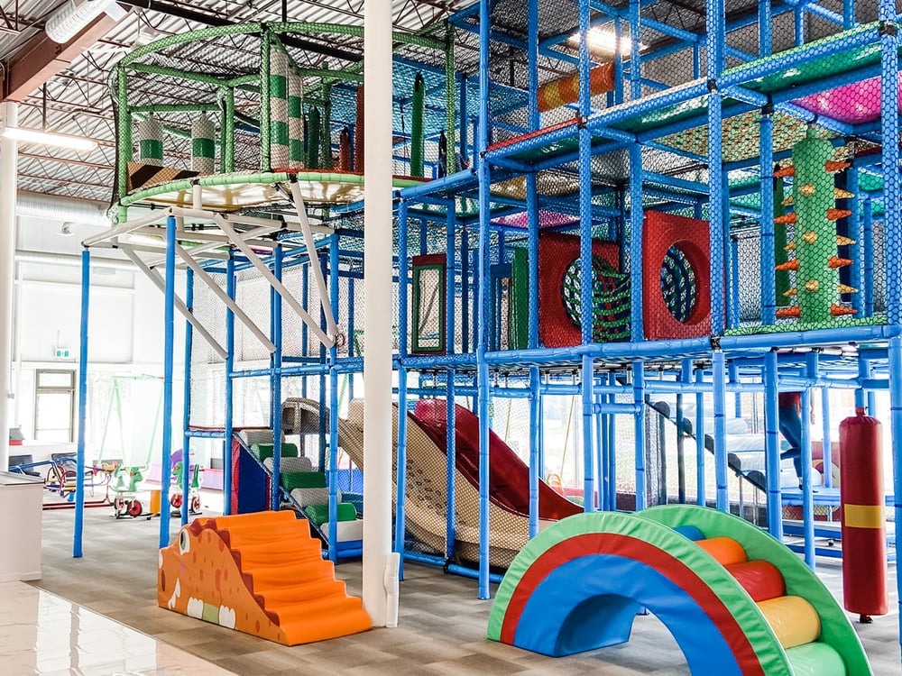 Indoor playground climbing structure at The Park YXE in Saskatoon.
