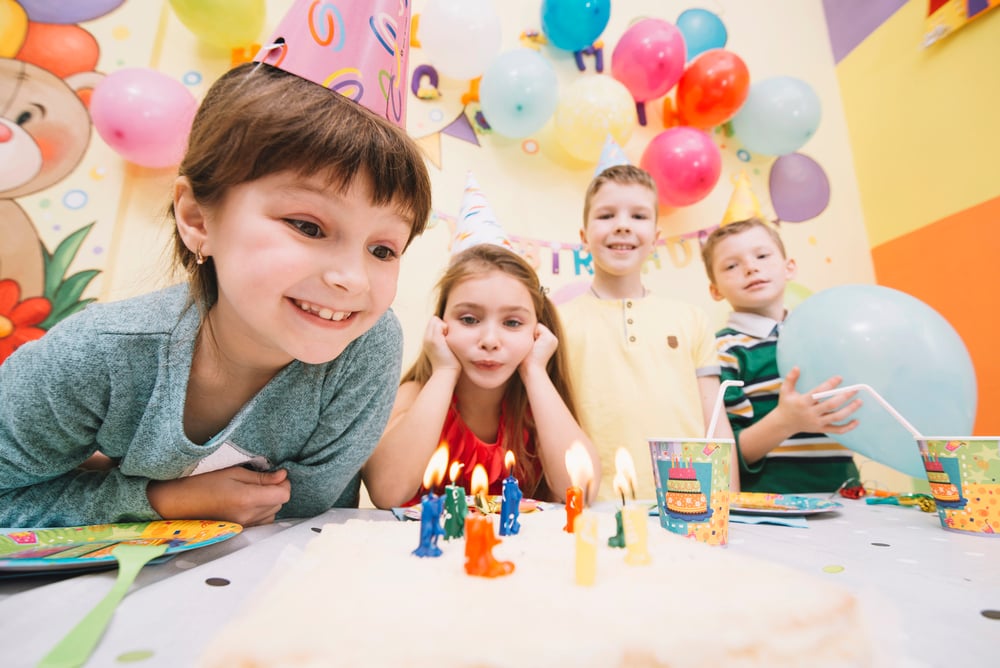 Children playing outdoor games at a birthday party.