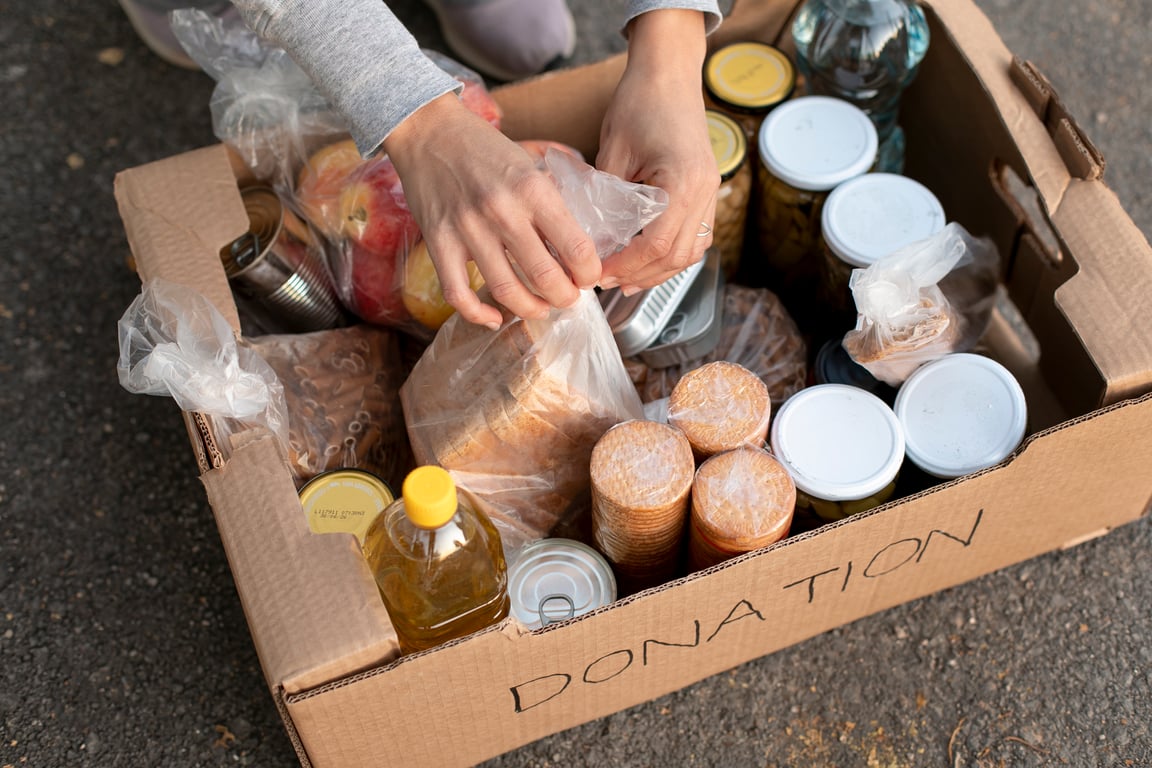 Second Harvest volunteer loading rescued food into a van for delivery to a local food bank.