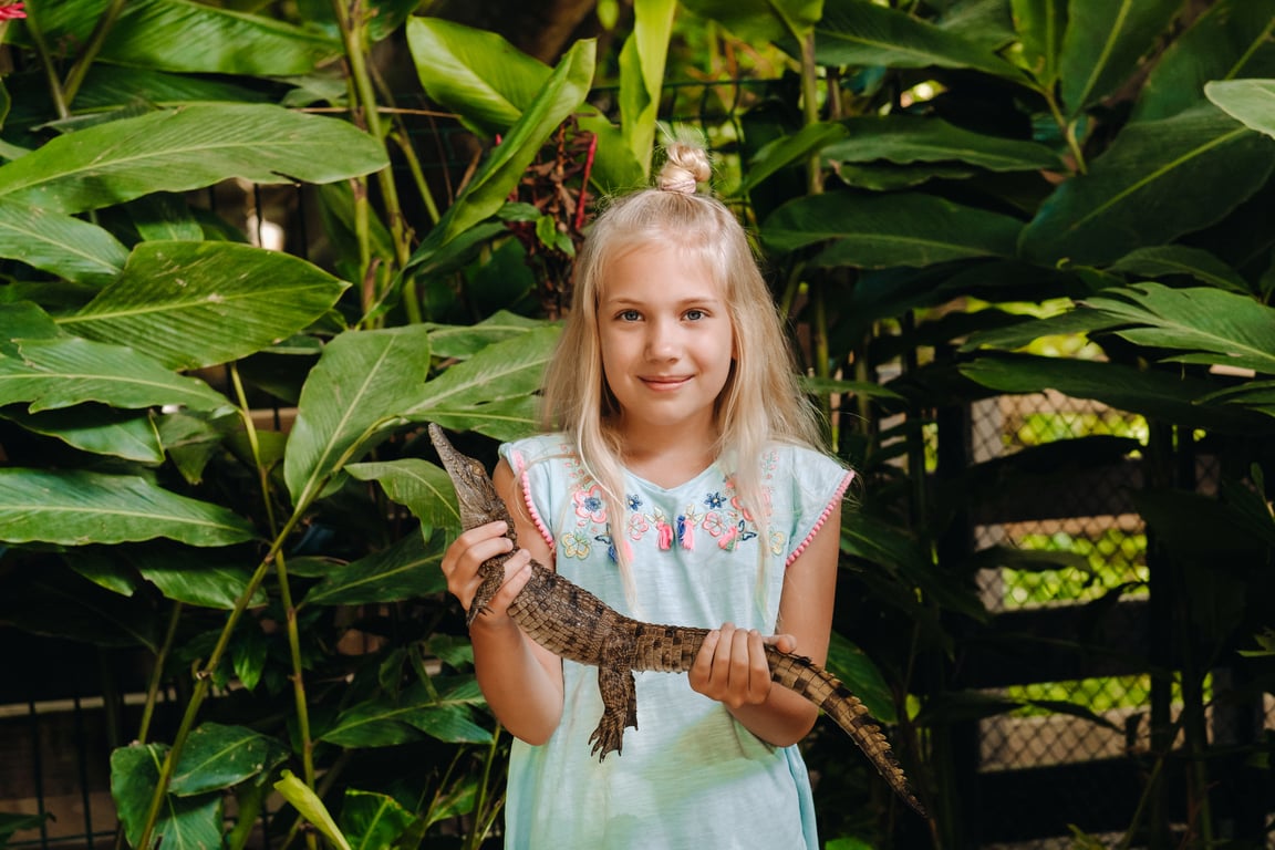 Girl holding a lizard, symbolizing WWF Canada’s conservation efforts.