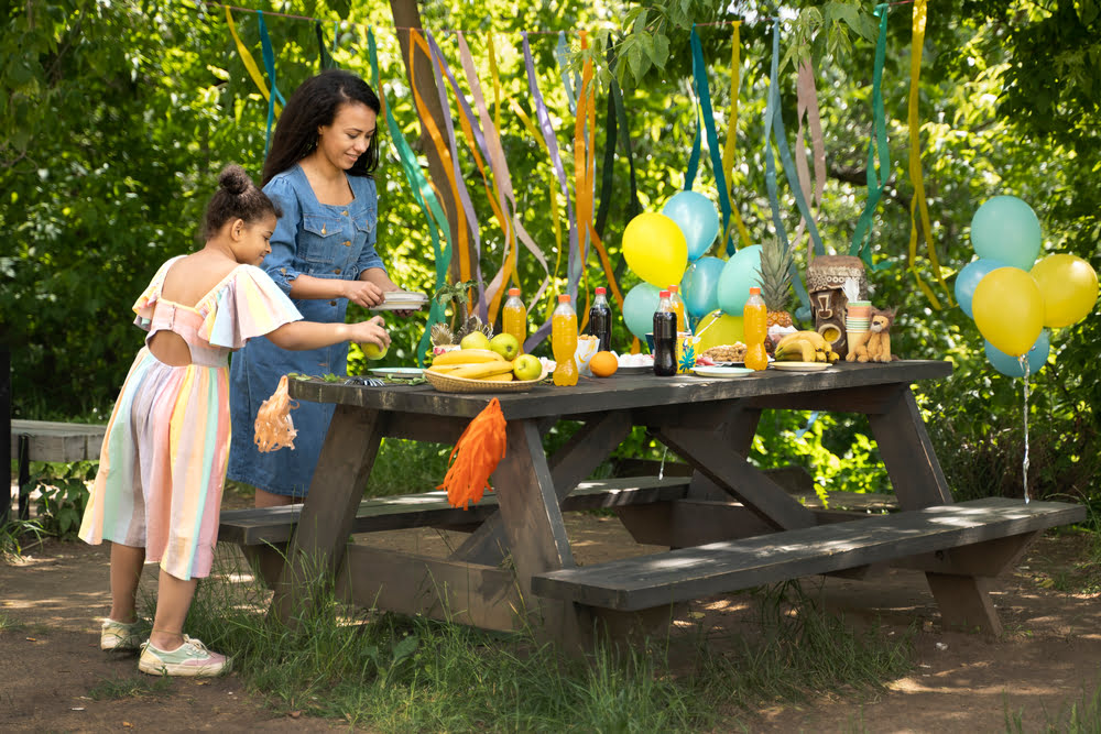Food and drinks set up for a backyard birthday party.