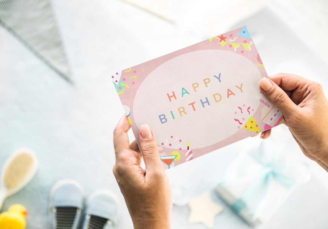 Parent holding a birthday card.