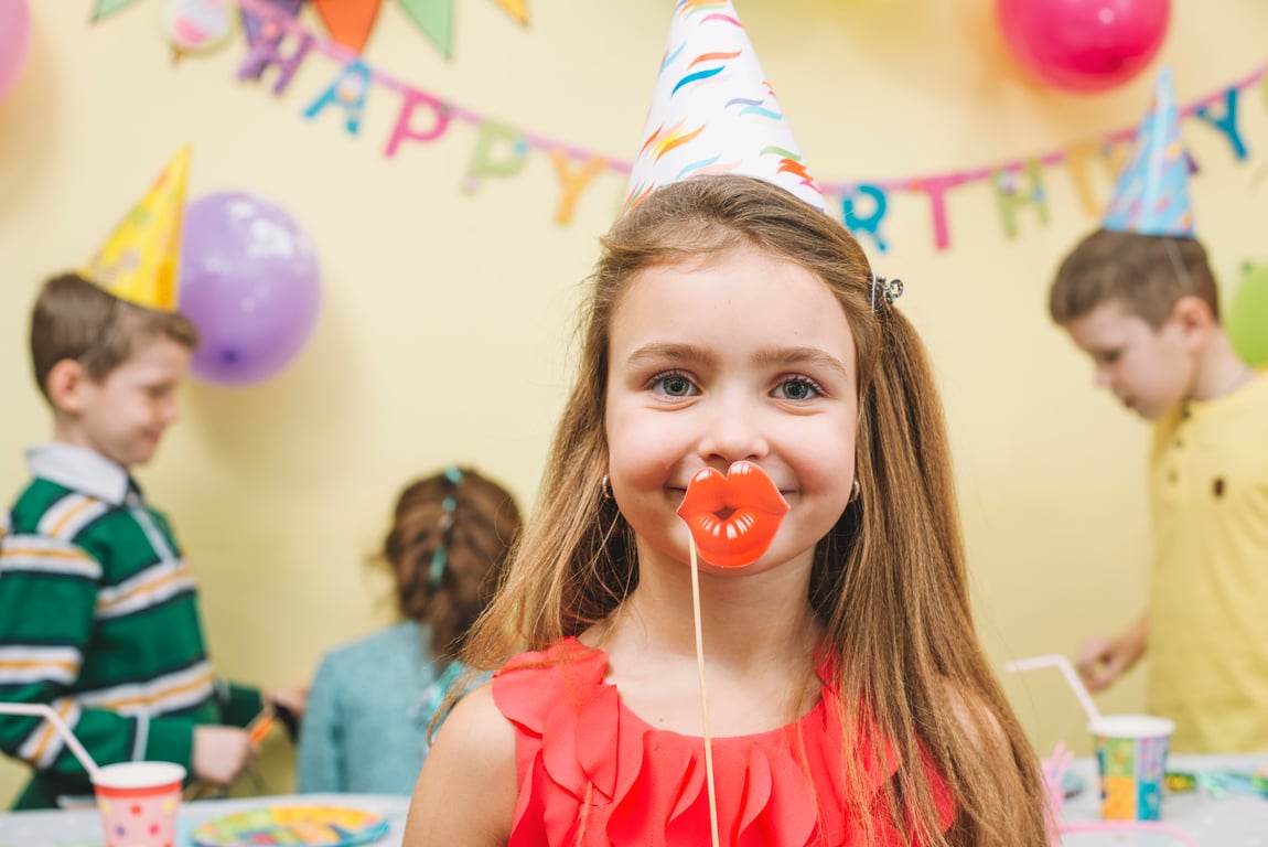 Happy child facing towards the camera celebrating.
