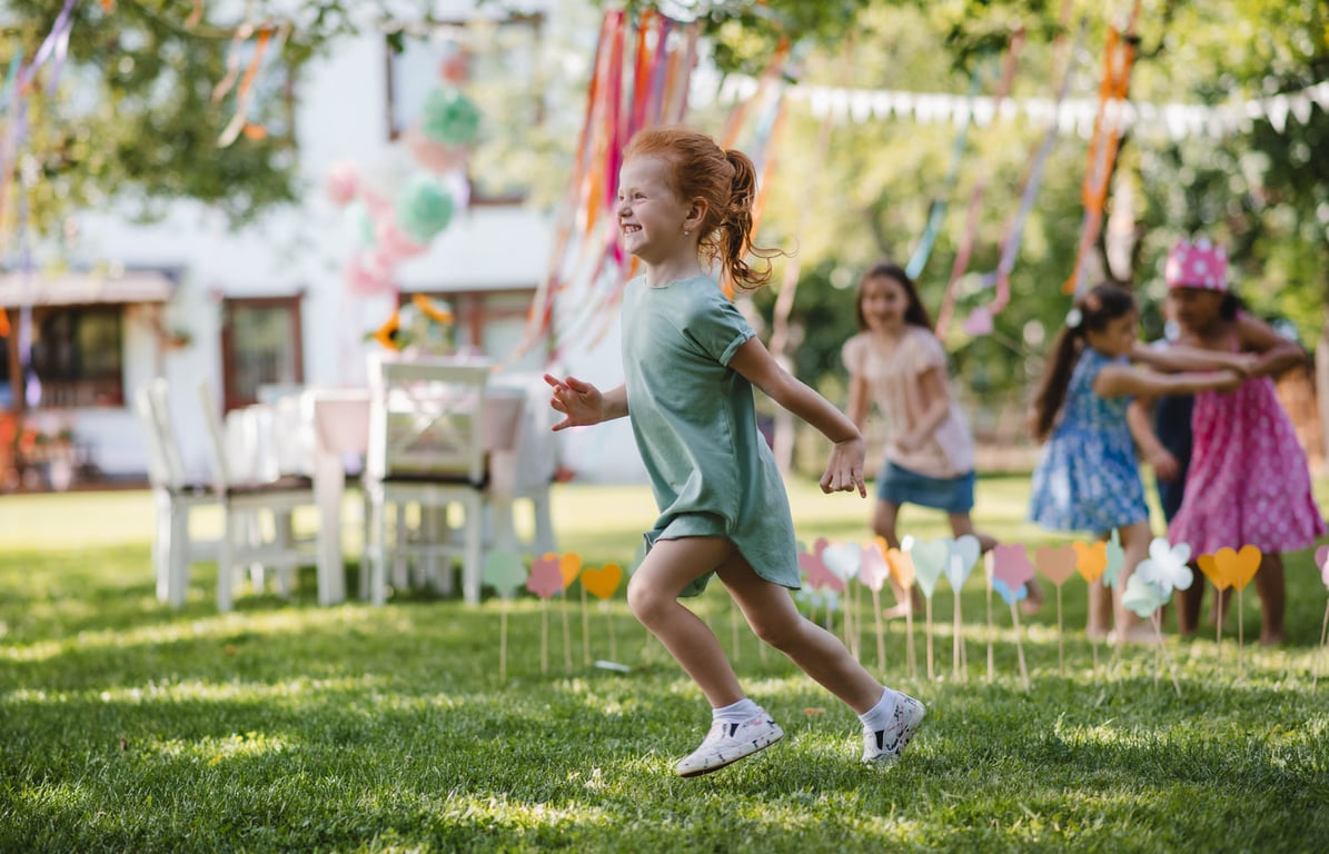 Outdoor sports birthday party setup with cones and equipment.