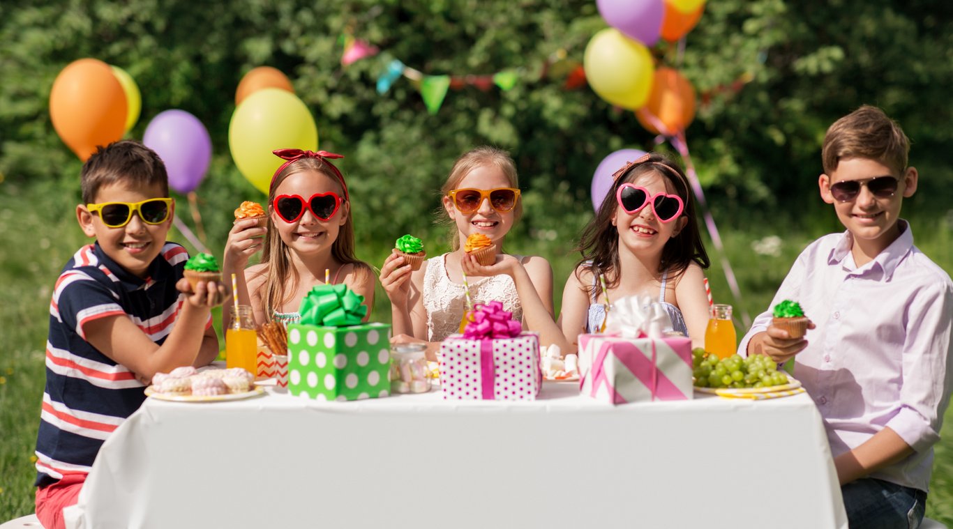 Kids eating cupcakes outside