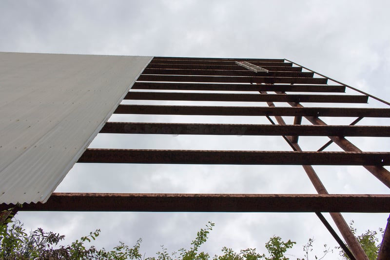 the screen tower,missing a panel now,a lot of trees cut down around screen now, and 2 ladders on the ground,also one ladder hanging from screen tower