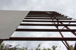 the screen tower,missing a panel now,a lot of trees cut down around screen now, and 2 ladders on the ground,also one ladder hanging from screen tower