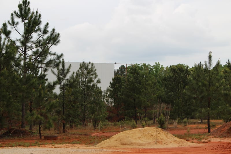 the screen tower,missing a panel now,a lot of trees cut down around screen now, and 2 ladders on the ground,also one ladder hanging from screen tower