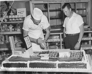 Felix Lacy picking up a birthday cake for the Fairview Drive-In.