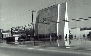 A vintage photo of the Rainbow Drive-in screen and marquee, after the swollen Coosa River flooded the lot