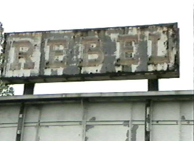 The weather beaten Rebel sign atop what was left of the marquee, the day the theatre was torn down.