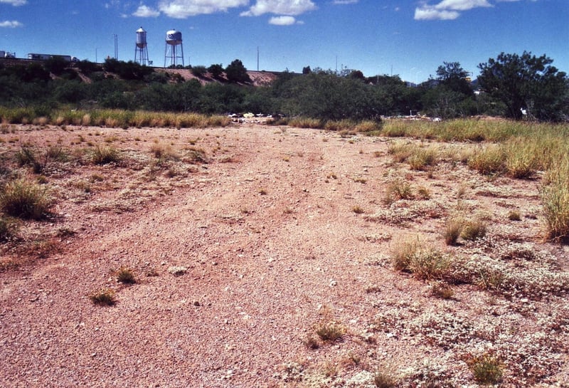 The field below the freeway. The traffic on the ramp in the background travels on I-10