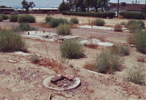 Picture of both ticket booth foundations. In the foregound is the remnant of a torched off steel beam once used for holding the side panels of the screen