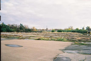 Former Screen 3 lot. Immediately behind the trees in the left side of the photo are homes.