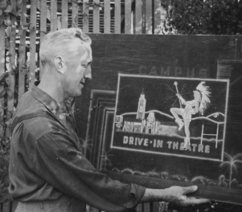 Joseph Schmith holding original Campus Drive-In Theater design on black showcard, watercolor with airbrush.