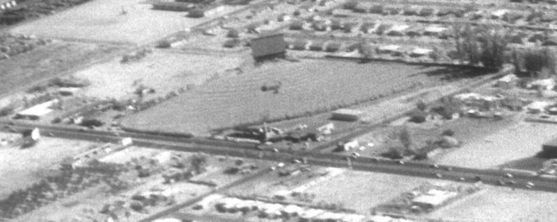 Aerial photo with the screen in back, refreshment building in middle, and car dealership and marquee in front along Foothill. The theater was operated and owned by William and Lecille Tharp. Unfortunately Twyla Tharp has no photo of her family's drive-in.