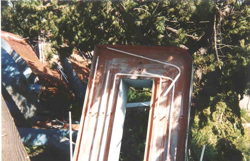 Reamins of neon sign that used to be on the back of the screen tower. The sign was dropped to the ground upon removal from the screen tower, resulting in a mass of twisted metal and neon shards in the bushes.