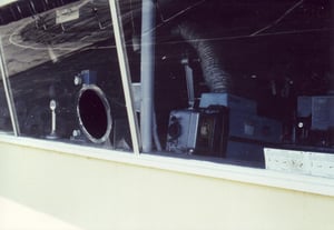 Projector behind window and porthole cut into glass