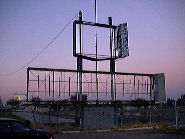 Composite aerial photograph of the Valley 99 Drive-In (1998). North is at the top of the photo, with the Clark Drive off-ramp in the top-left (northwest) corner. The theater's parking area is faintly visible at right-center, looking somewhat like a baseba