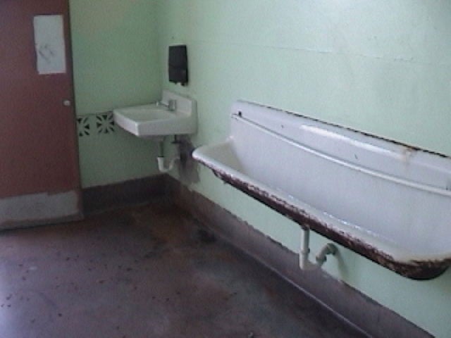 Men's bathroom, showing sink and urinal basin.