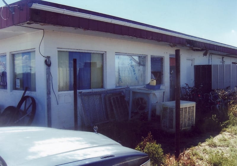 Behind the windows of the former concession building is the office of the body shop