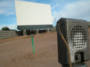 drive-in speaker and screen in background