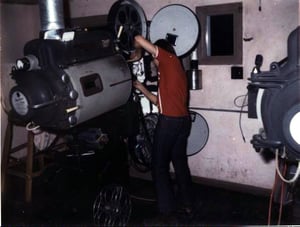 Here is a picture of me threading the projector at age 14. I was a very good projectionist, I made change overs from Reel to Reel. I always was on the screen at all times inspected the film before running the Movies. I took pride in the Motion Picture Pre