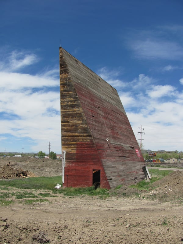 Wooden projection screen structure is all that remains of this historic drive-in theater. Gravel pit expansion is moving quickly now, all other structures of this theater have been demolished. This screen has been a landmark on the East side of Craig CO