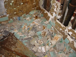 What's left of the seafoam green tile in the restroom.