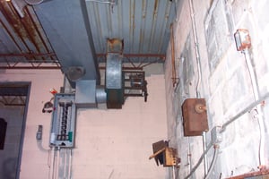 View of inside of old projection booth taken from a small hole in side of building.