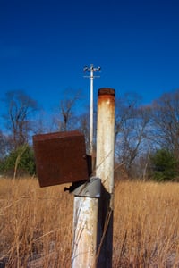 Speaker post with light tower in background.