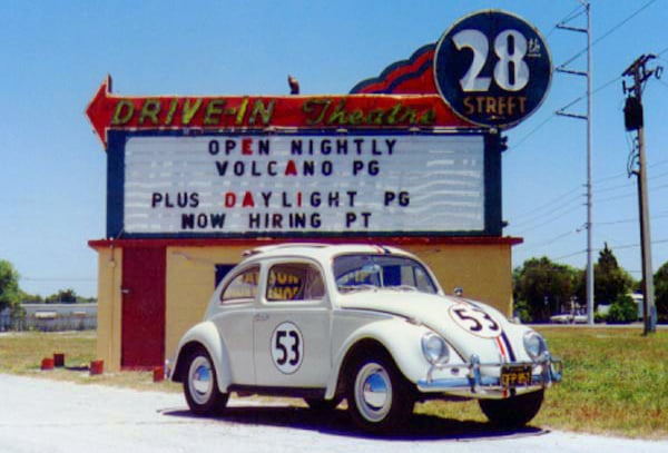 Herbie The Love Bug sits in front of the 28th Street Drive in marquee.
