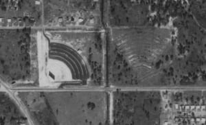 Aerial view at opening. Note abandoned excavation (Drive-In next door)