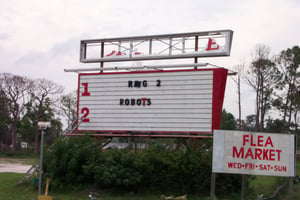 Close-up view of marquee showing hurricane damage.