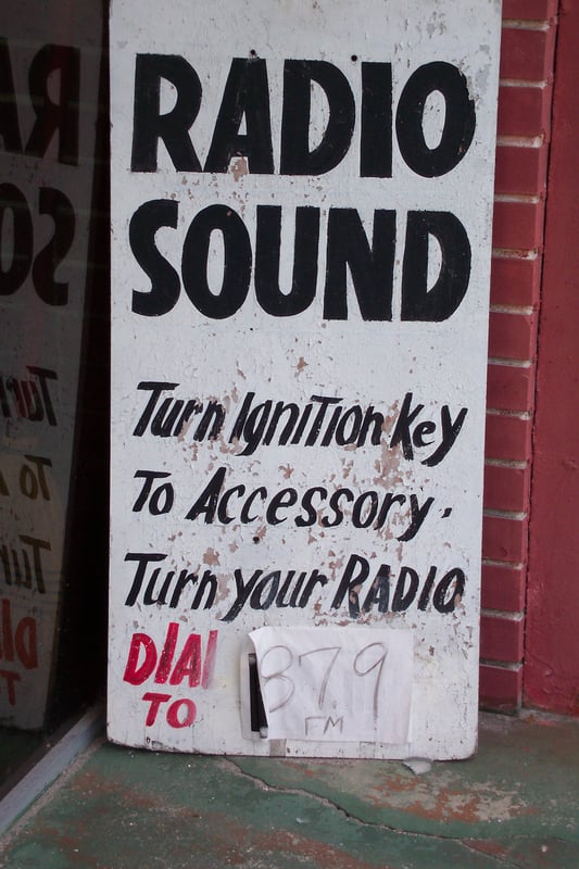 Radio frequency sign on ticket booth wall.