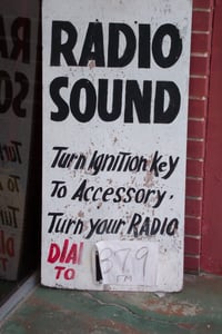 Radio frequency sign on ticket booth wall.